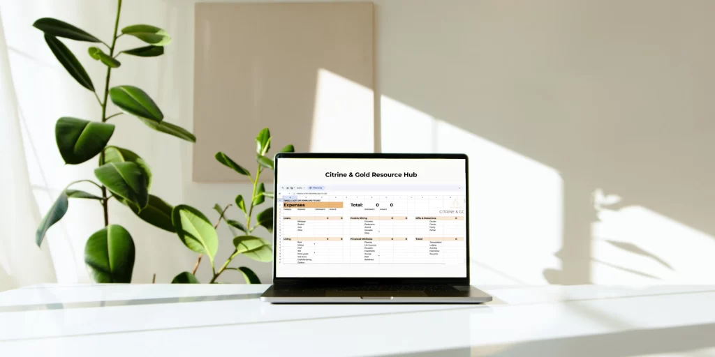 laptop open on desk with Citrine & Gold's budget spreadsheet on display