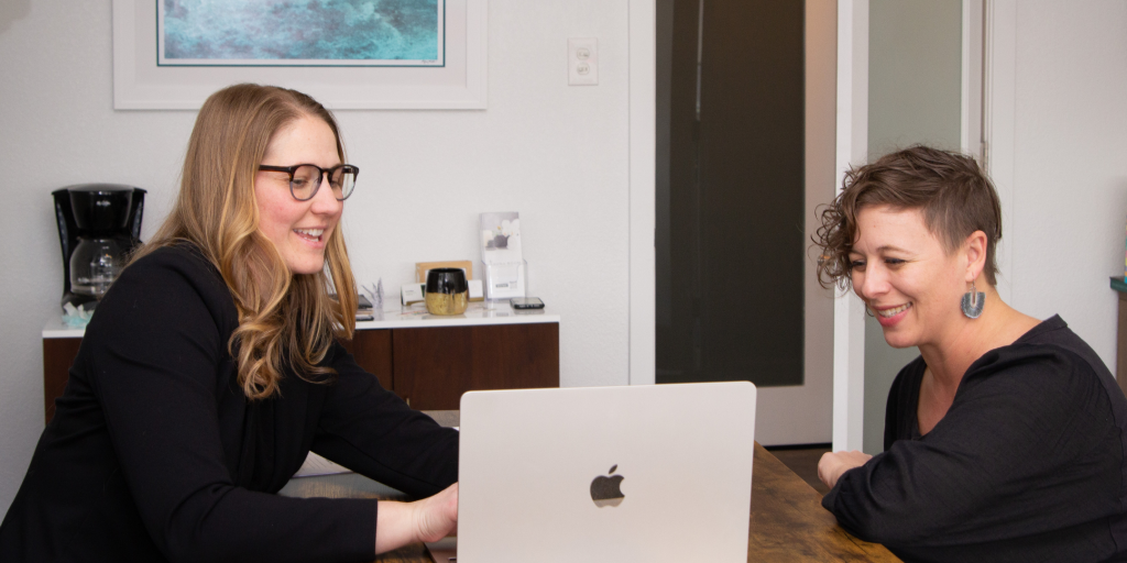 Brynna Wilson, a financial advisor for millennials meeting with a smiling client