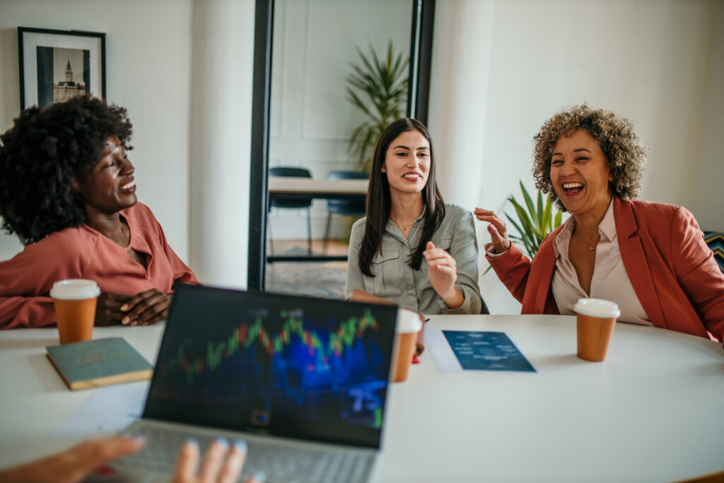 group of professional women discussing how to navigate market volatility