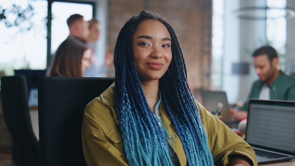 gen z investor smiling at the camera