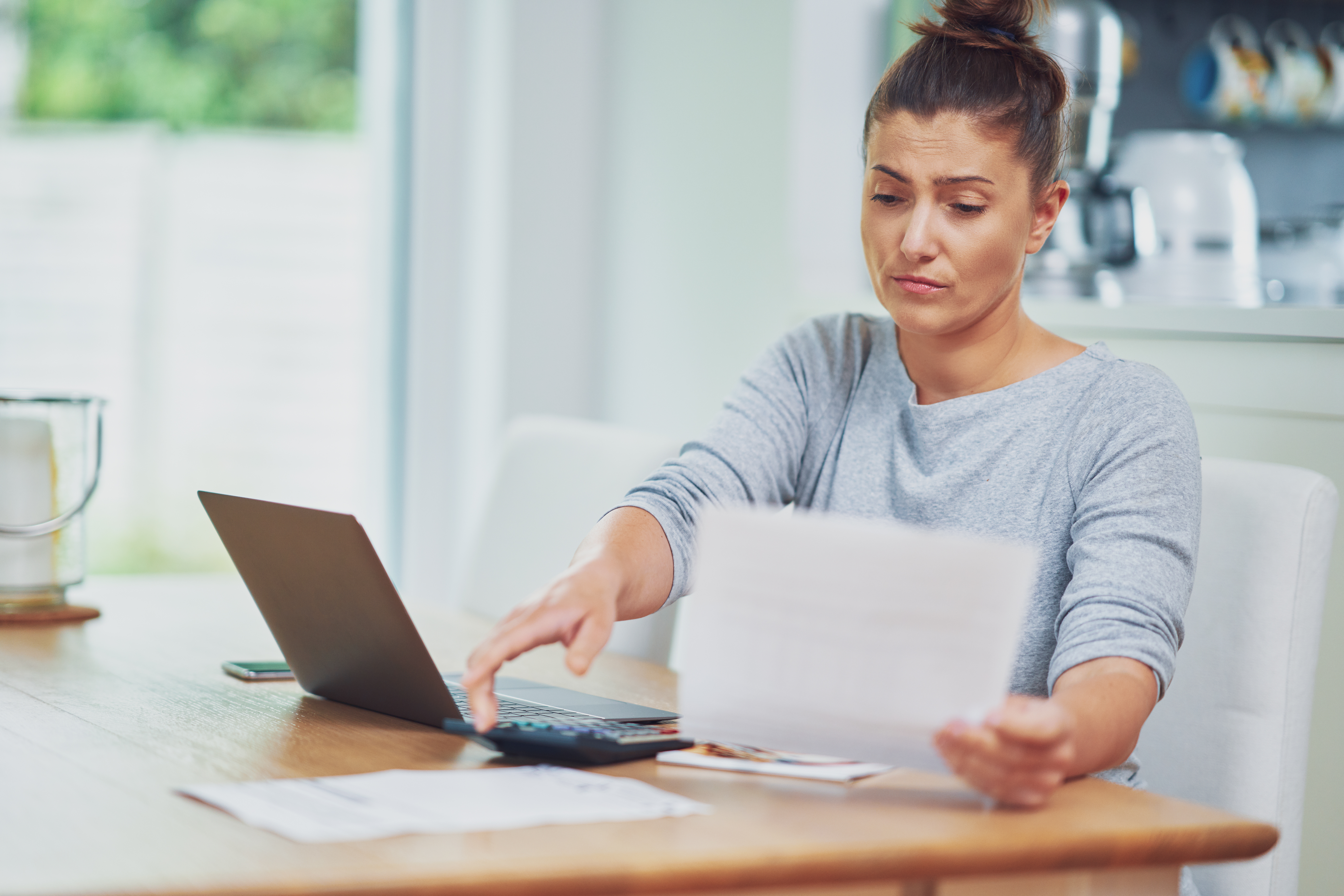woman taking inventory of her financial accounts after divorce